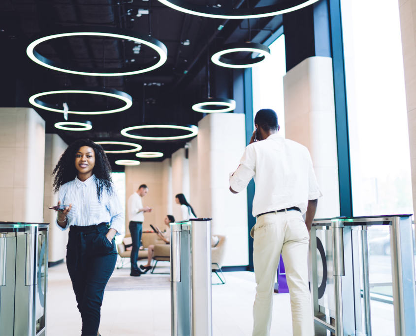 Content coworkers going through access control at workplace