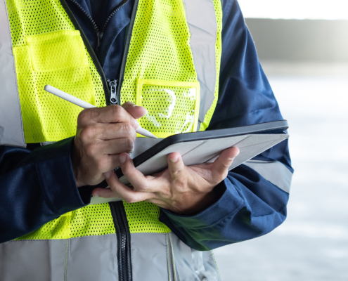 Building inspector man using digital tablet checking safety and security system