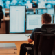 Male security operator working in a data system control room